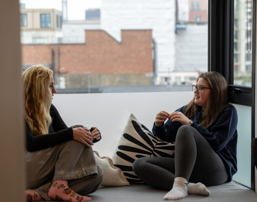 Students sitting together in studio